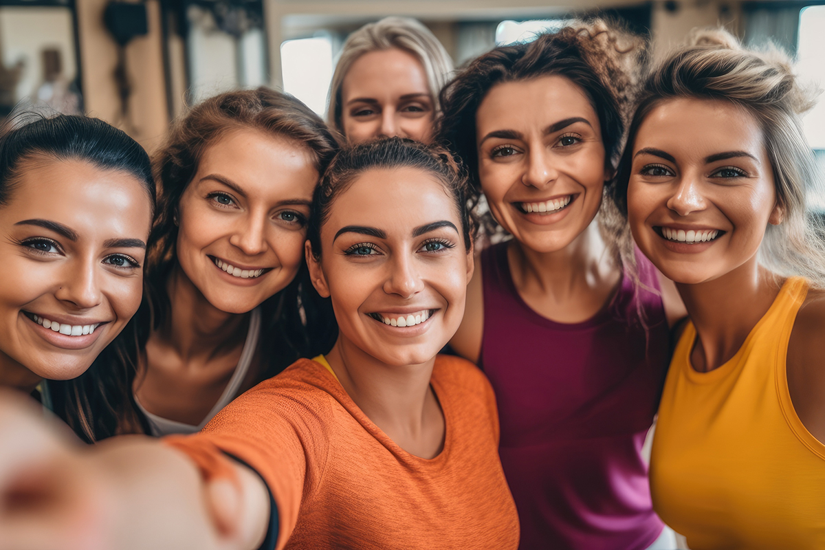 Group of happy people taking a selfie together in a yoga studio