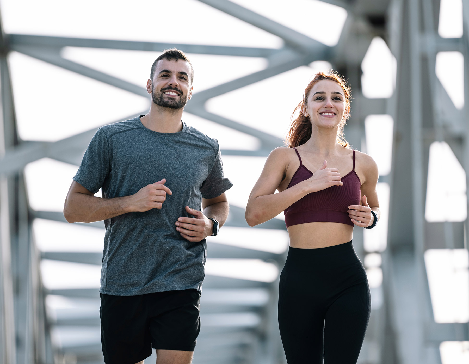 Happy athletic couple having fun while running